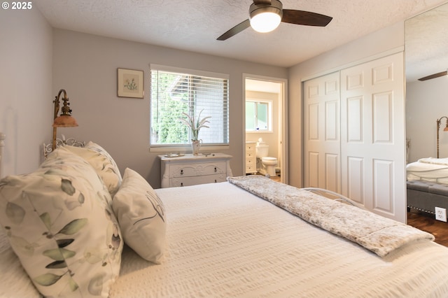 2416 SW 23rd Cir, Troutdale, OR 97060 - bedroom featuring a closet, wood finished floors, a ceiling fan, ensuite bath, and a textured ceiling