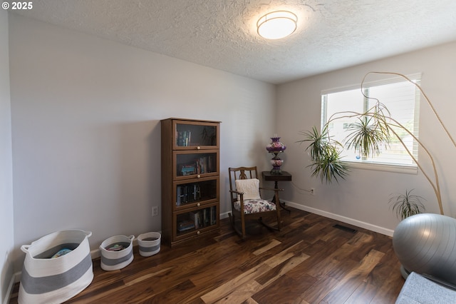 2416 SW 23rd Cir, Troutdale, OR 97060 - sitting room with dark wood-type flooring, a textured ceiling, and baseboards