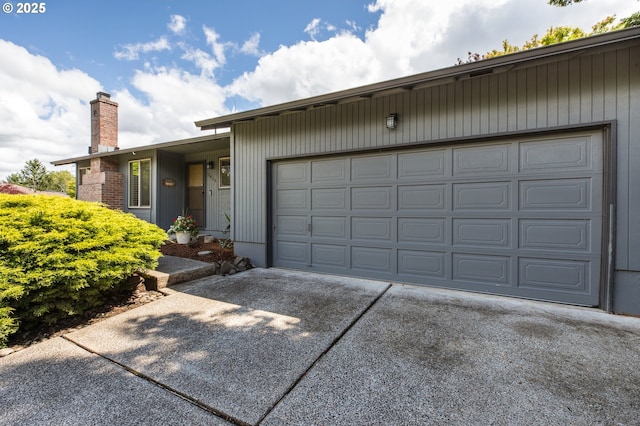 2416 SW 23rd Cir, Troutdale, OR 97060 - view of front facade featuring a chimney, concrete driveway, and a garage