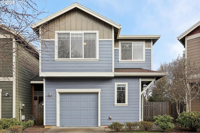 view of front of property featuring board and batten siding, an attached garage, and fence