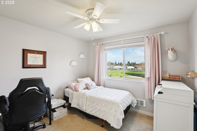 bedroom featuring ceiling fan, baseboards, visible vents, and light colored carpet