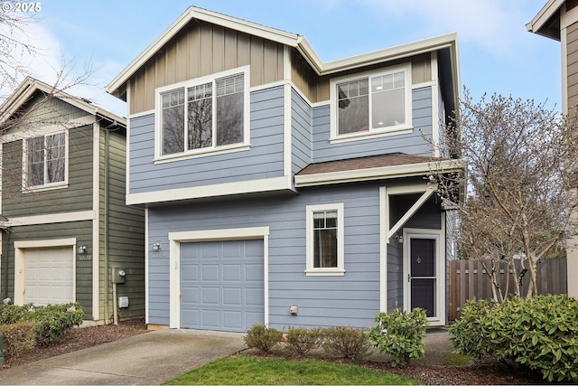 view of front of house featuring an attached garage, driveway, fence, and board and batten siding