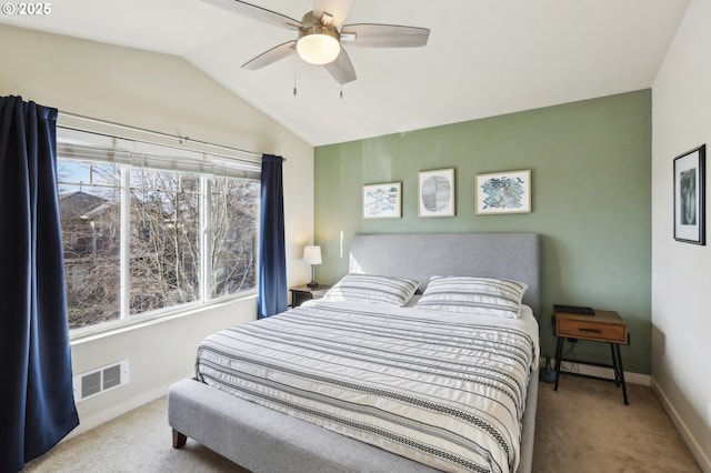 carpeted bedroom with lofted ceiling, baseboards, visible vents, and ceiling fan