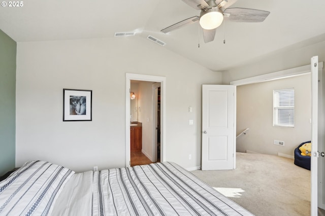 unfurnished bedroom featuring visible vents, vaulted ceiling, light carpet, and ceiling fan