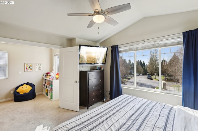 bedroom featuring a ceiling fan, lofted ceiling, light colored carpet, and baseboards