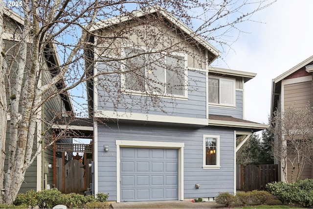 view of front of home with an attached garage and fence