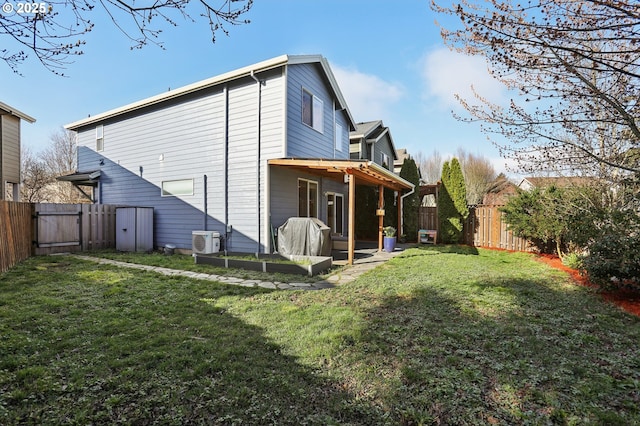 back of property with ac unit, a fenced backyard, and a lawn