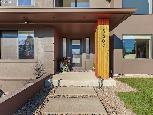 entrance to property featuring stucco siding