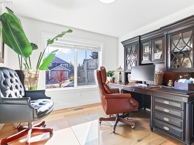 office featuring wood finished floors, visible vents, and baseboards