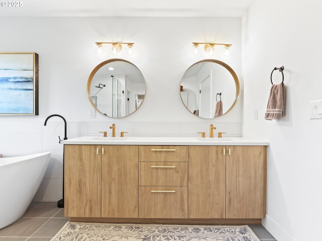 full bath with double vanity, a soaking tub, tile patterned flooring, and a sink