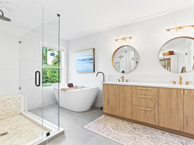 bathroom featuring a shower stall, a sink, and tile patterned floors