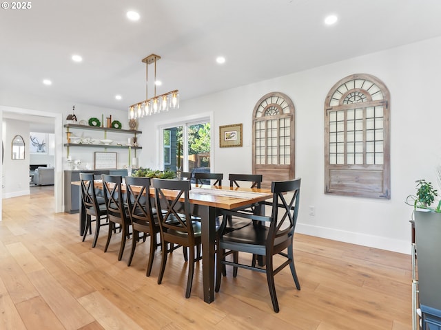 dining space with baseboards, light wood-type flooring, and recessed lighting