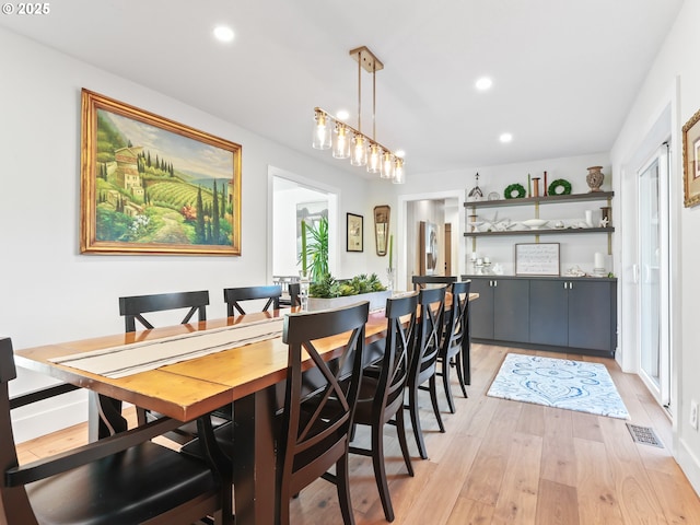 dining area featuring light wood finished floors, visible vents, and recessed lighting