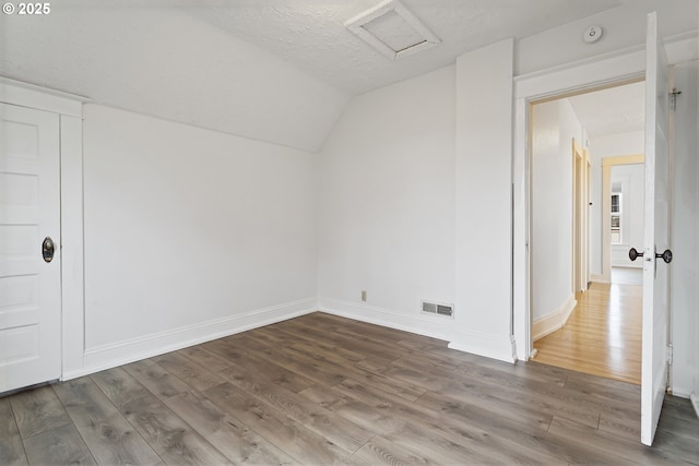 4903 SE Haig St, Portland, OR 97206 - additional living space with attic access, vaulted ceiling, wood finished floors, and a textured ceiling