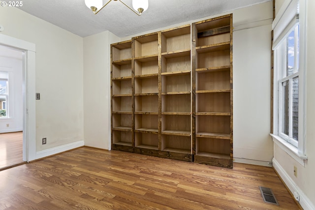 4903 SE Haig St, Portland, OR 97206 - unfurnished room with wood finished floors and a textured ceiling