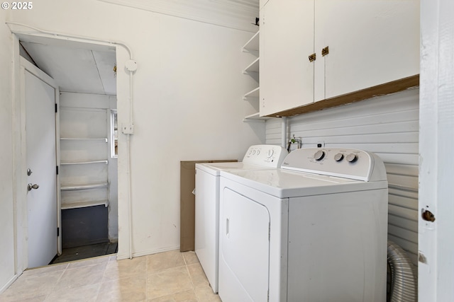 4903 SE Haig St, Portland, OR 97206 - washroom featuring washer and clothes dryer, cabinet space, and light tile patterned flooring