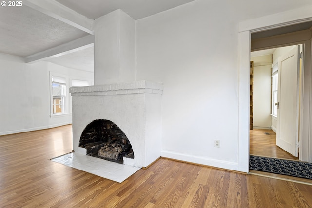 4903 SE Haig St, Portland, OR 97206 - unfurnished living room featuring wood finished floors and a fireplace with flush hearth