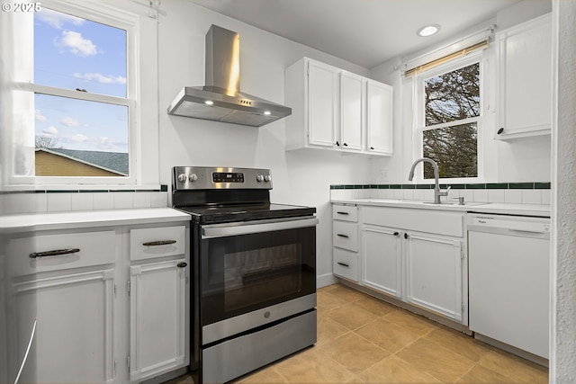 4903 SE Haig St, Portland, OR 97206 - kitchen with wall chimney range hood, electric stove, white dishwasher, and light countertops