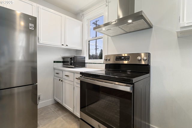 4903 SE Haig St, Portland, OR 97206 - kitchen with stainless steel appliances, wall chimney range hood, white cabinetry, light countertops, and light tile patterned floors