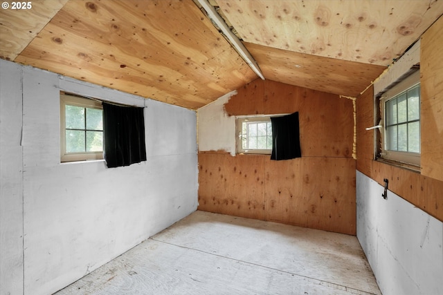 additional living space with lofted ceiling, wooden walls, and wood ceiling