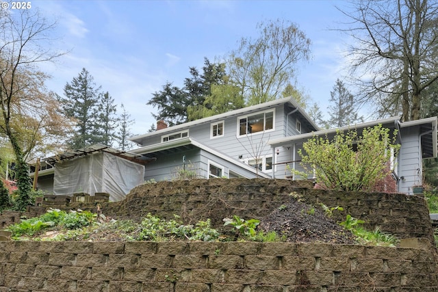rear view of property with a chimney