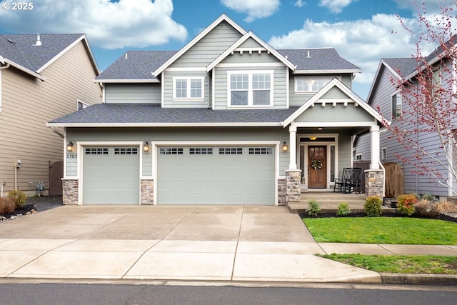 craftsman-style home featuring concrete driveway, an attached garage, stone siding, and a shingled roof