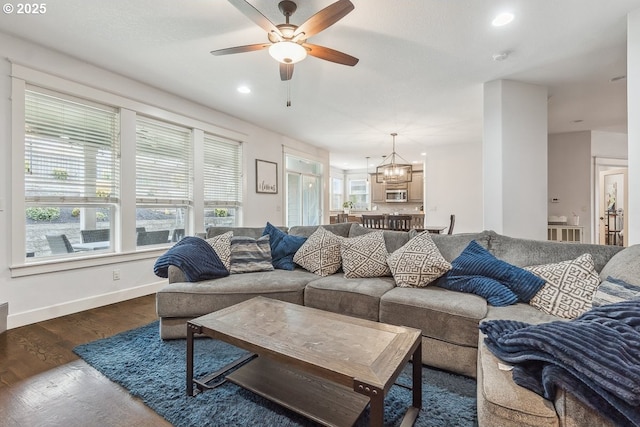 living room featuring recessed lighting, baseboards, plenty of natural light, and dark wood-style floors