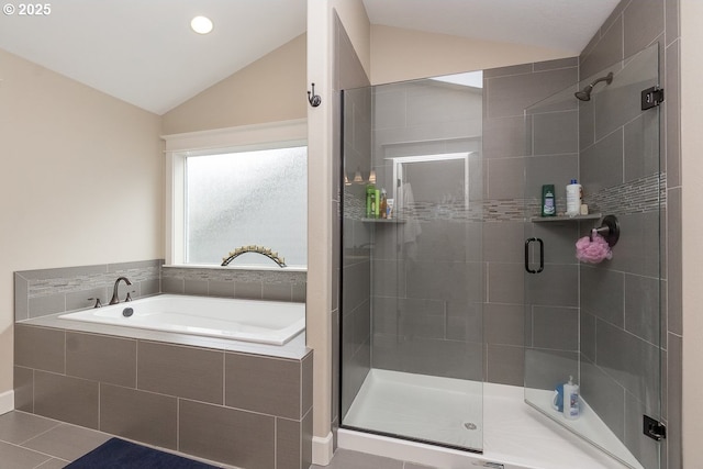 bathroom with lofted ceiling, a bath, and a shower stall