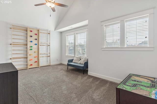 living area featuring a ceiling fan, baseboards, carpet floors, and high vaulted ceiling