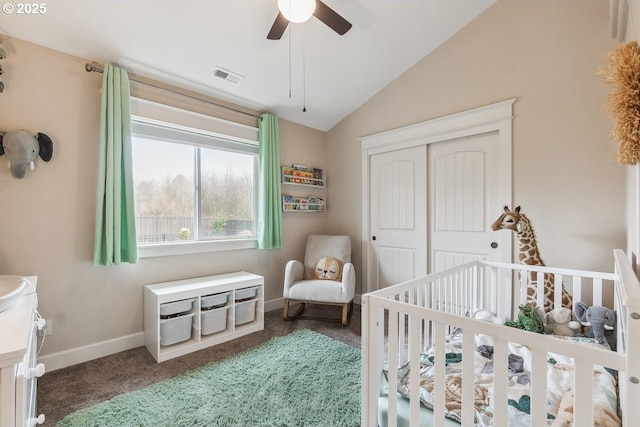 bedroom featuring visible vents, lofted ceiling, a closet, carpet floors, and baseboards