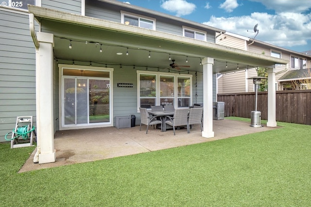 rear view of property with a lawn, a patio, central AC, fence, and ceiling fan