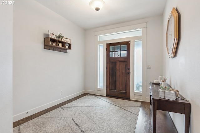 entrance foyer featuring baseboards and wood finished floors