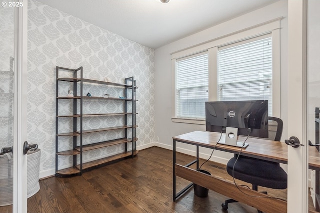 office area with wallpapered walls, wood finished floors, baseboards, and french doors