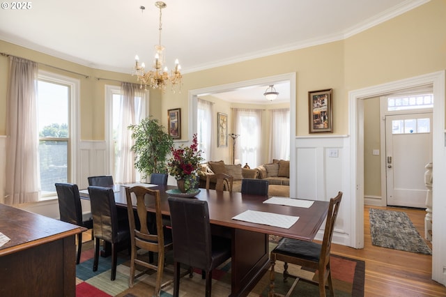 dining room featuring hardwood / wood-style flooring, ornamental molding, and plenty of natural light