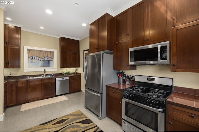 kitchen featuring ornamental molding, appliances with stainless steel finishes, and sink