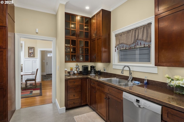 kitchen featuring sink, crown molding, dark stone countertops, dishwasher, and light hardwood / wood-style floors