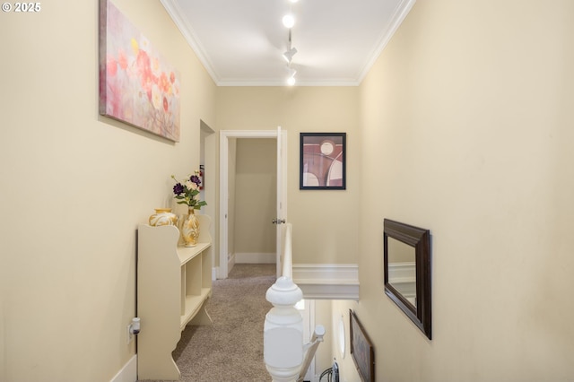 hall featuring crown molding, track lighting, and light carpet