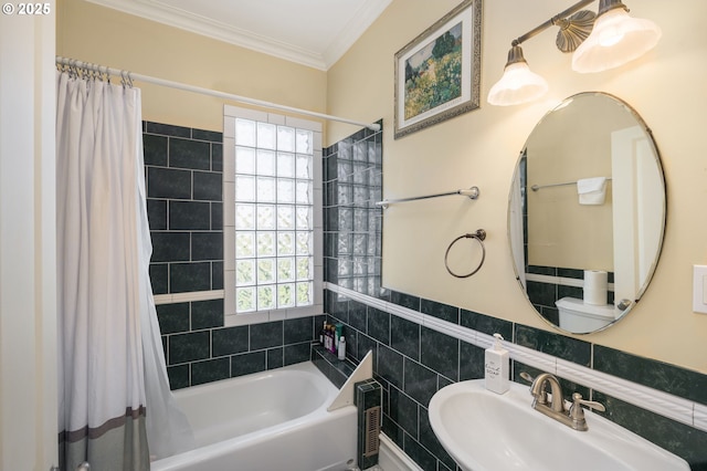 full bathroom featuring ornamental molding, plenty of natural light, sink, and tile walls