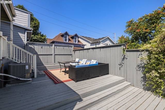 wooden deck featuring cooling unit and an outdoor hangout area