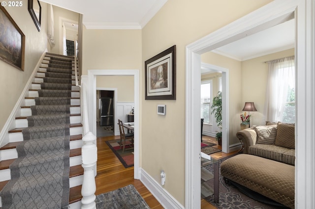 interior space featuring crown molding and hardwood / wood-style floors