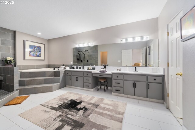bathroom with two vanities, a bath, tile patterned flooring, and a sink