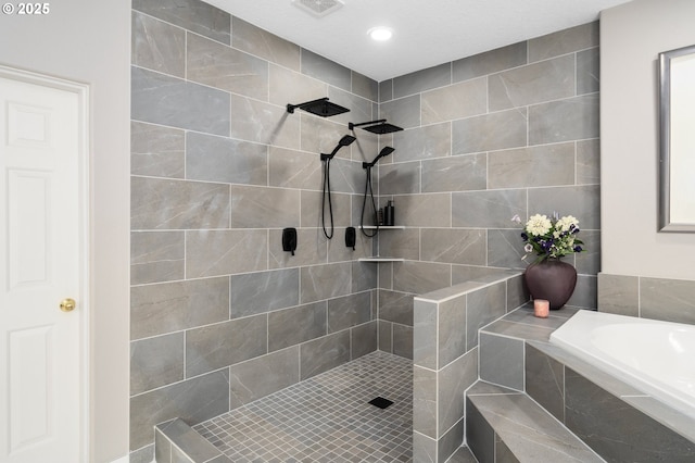 bathroom with visible vents, recessed lighting, a bath, and tiled shower