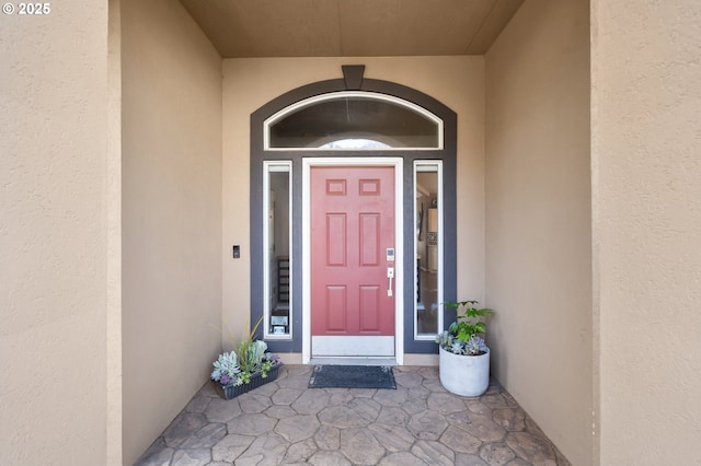 doorway to property with stucco siding