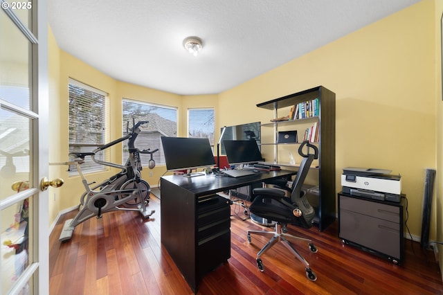 office with hardwood / wood-style flooring and baseboards