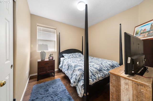 bedroom featuring wood finished floors and baseboards