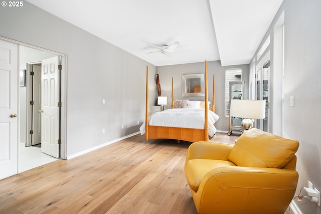 bedroom with baseboards and light wood finished floors