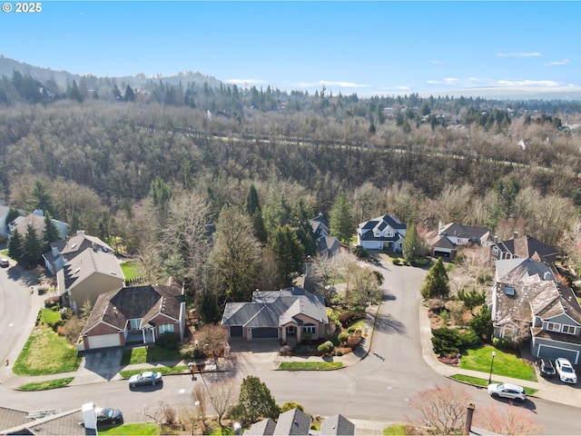 bird's eye view with a wooded view and a residential view