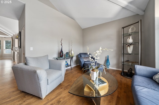 living room featuring baseboards, wood finished floors, and lofted ceiling