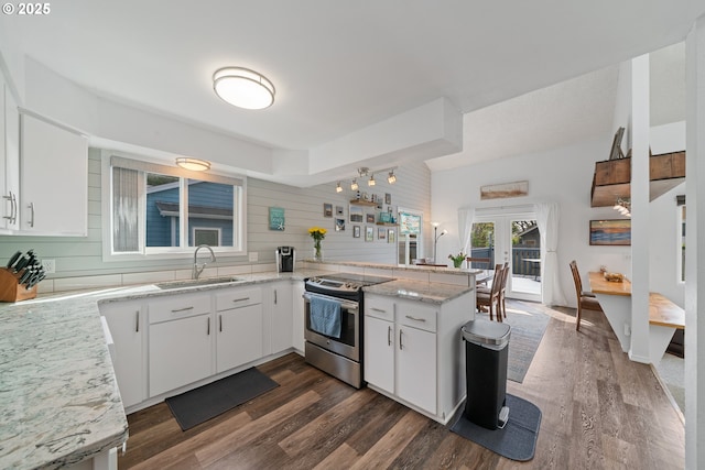 kitchen with stainless steel electric range oven, a sink, french doors, a peninsula, and dark wood-type flooring