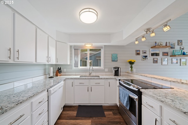kitchen with dark wood-type flooring, white dishwasher, white cabinets, and stainless steel range with electric cooktop